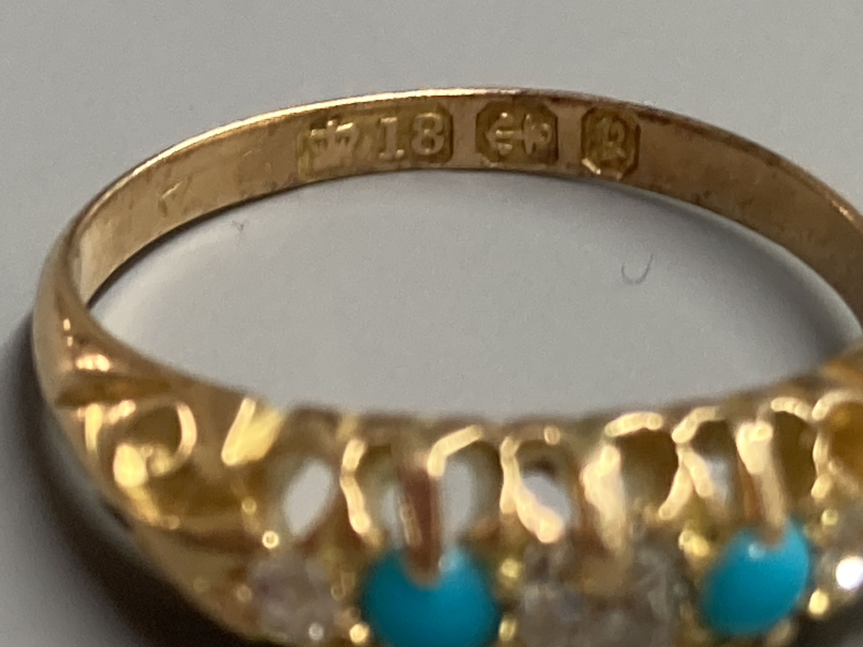 A late Victorian 18ct gold, three stone diamond and two stone turquoise set half hoop ring, size L, gross 3.4 grams.